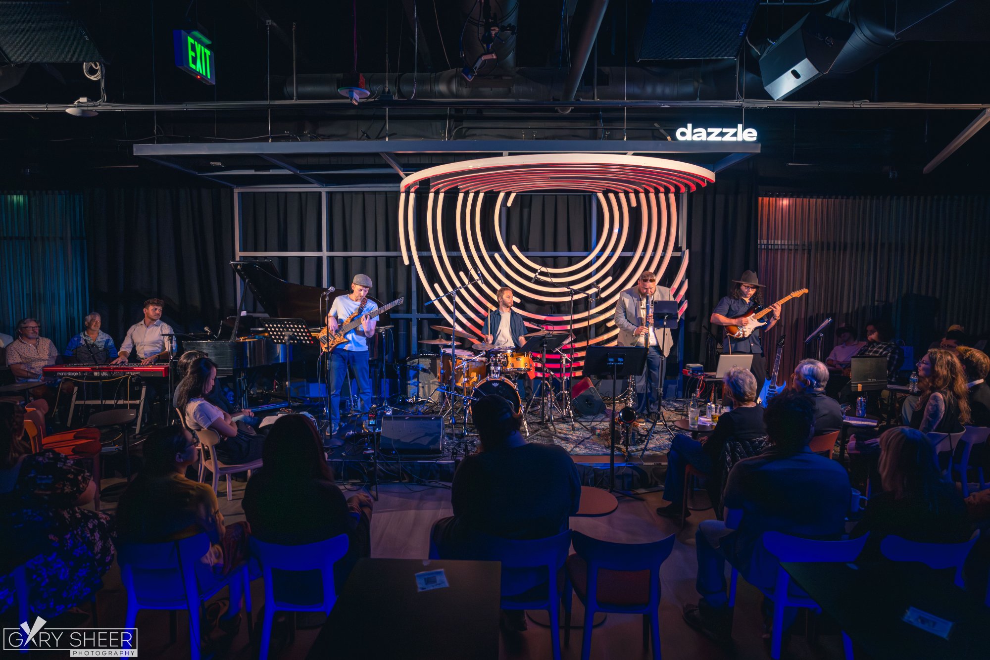Chick Magnet on stage at Dazzle Denver with a full audience