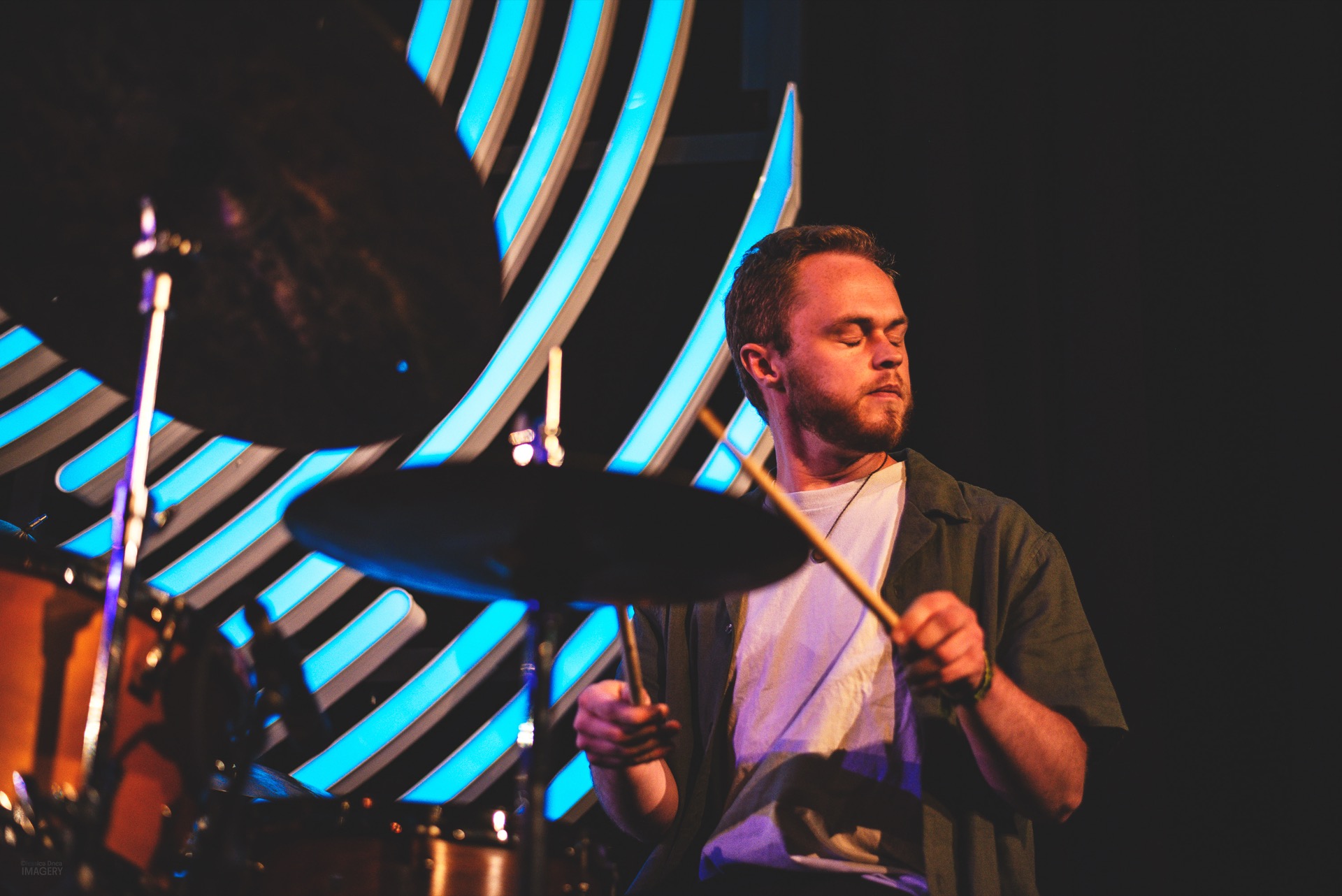 Drummer and saxophonist under the Dazzle neon rings