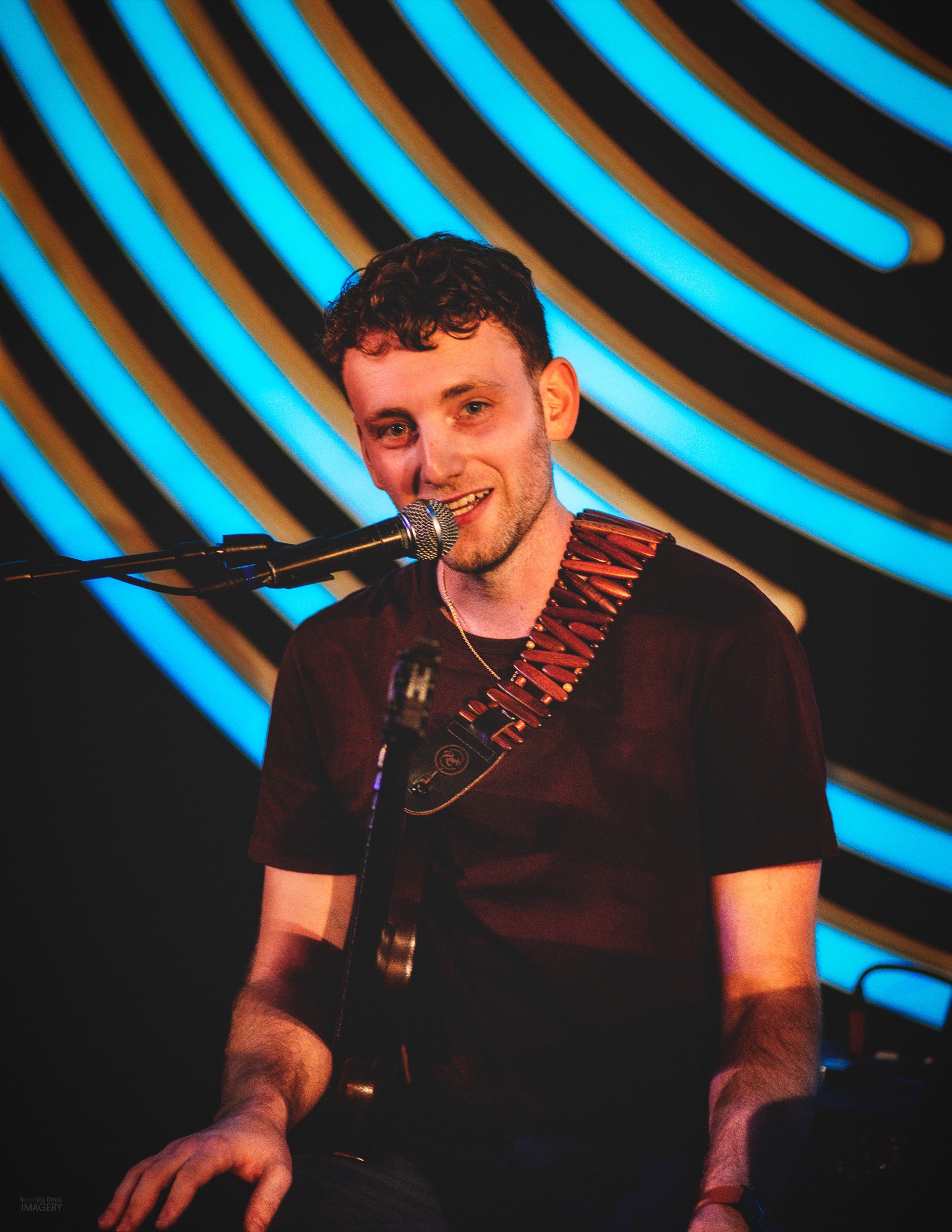 Jordan Lovinger smiling on stage with Chick Magnet